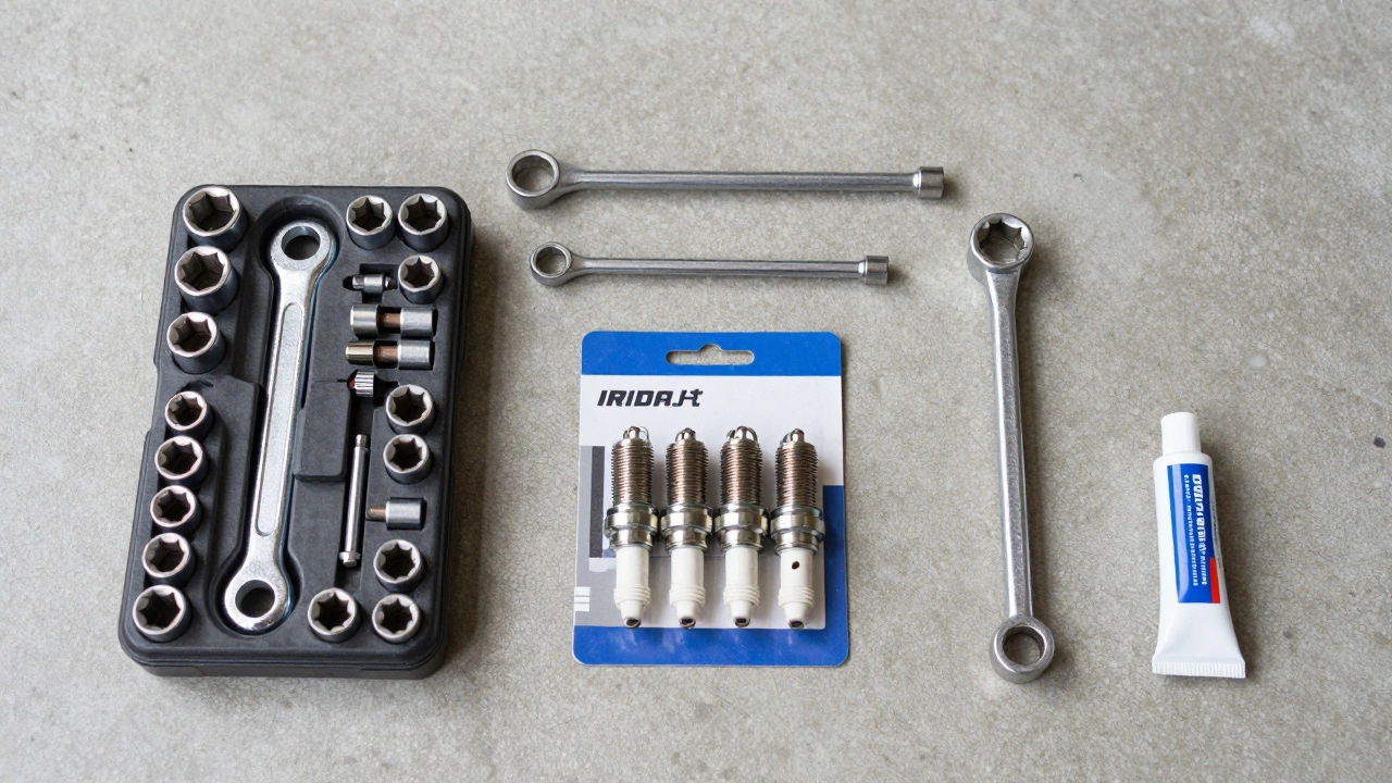 Organized DIY car repair tools and new spark plugs laid out on garage floor for replacement.